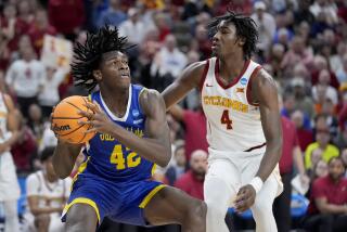 South Dakota State's William Kyle III holds the ball under pressure from Iowa State's Demarion Watson 