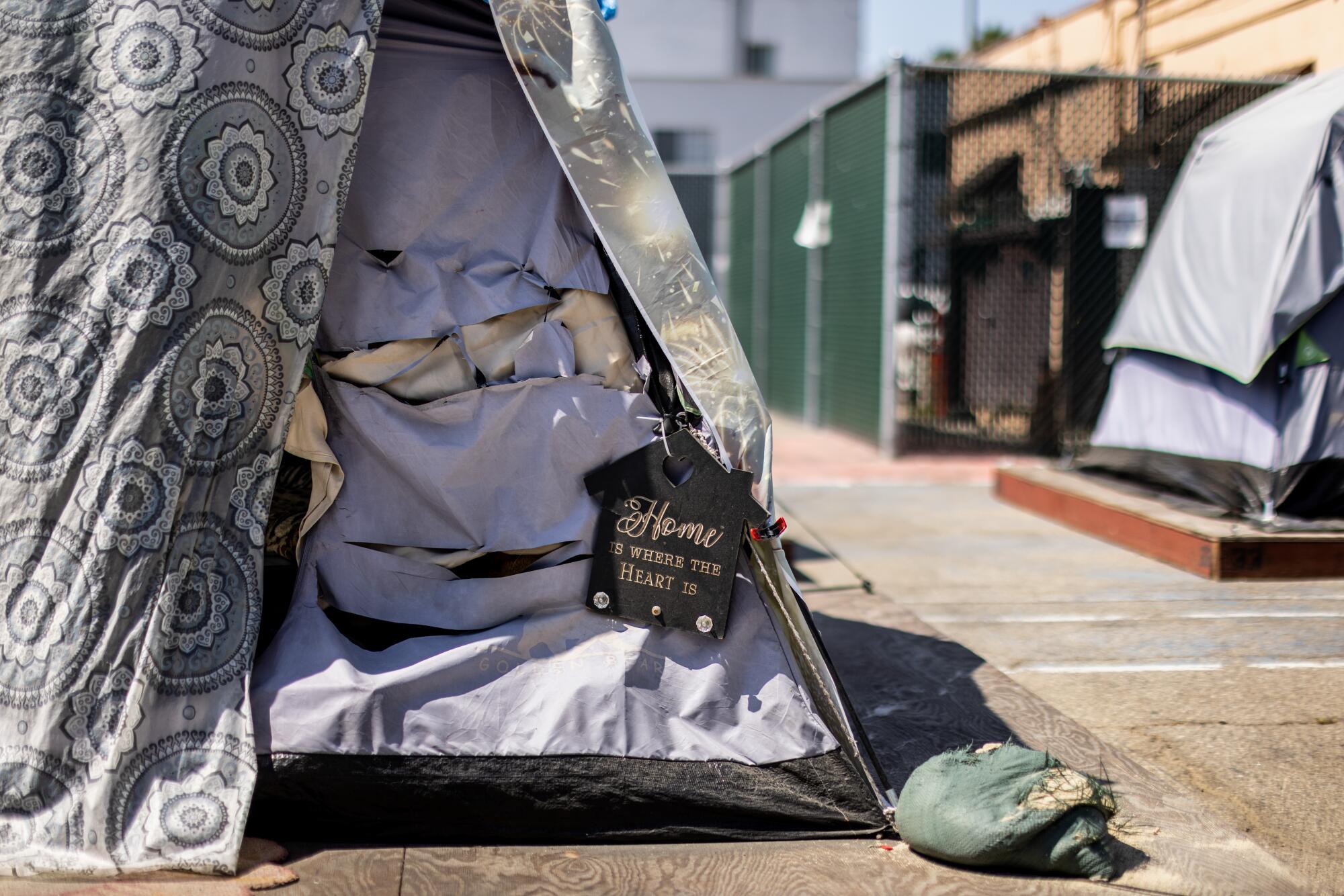 A tent is decorated with a sign that reads, "Home is where the Heart is." 
