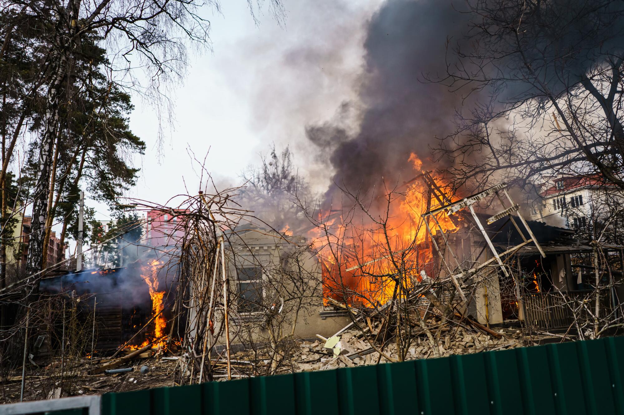 Flames roar in a damaged home.