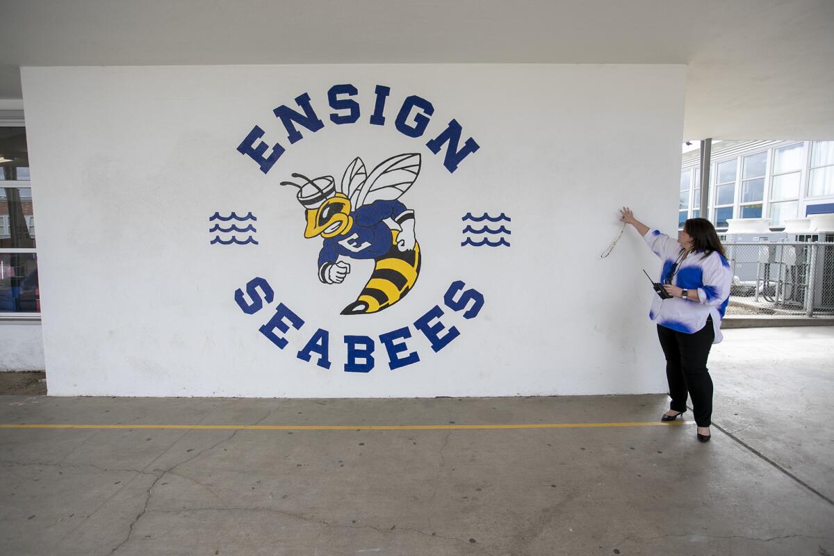 Ensign Intermediate School Principal Samantha Payne shows off one of the murals that Jennifer Bloomfield painted on campus.