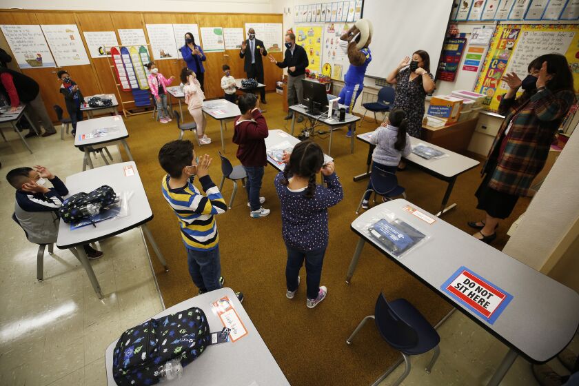 MAYWOOD, CA - APRIL 13: Kindergarten students sing and dance in the kindergarten classroom of teacher Dora Barraza at Heliotrope Avenue Elementary School in Maywood Tuesday morning as some students are attending a LAUSD campus for the first time in more than a year, as some Los Angeles Unified schools reopen for in-person classes, with safety standards and mandatory COVID-19 testing of students in place. Heliotrope Avenue Elementary School on Tuesday, April 13, 2021 in Maywood, CA. (Al Seib / Los Angeles Times).