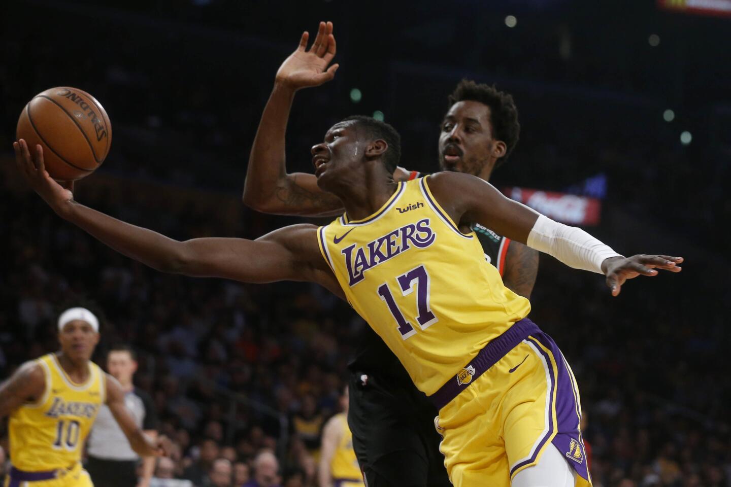 Lakers guard Isaac Bonga drives around Al-Farouq Aminu.