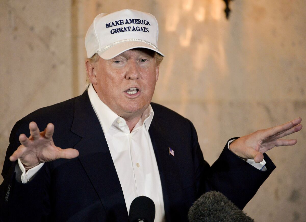 Republican presidential hopeful Donald Trump speaks during a brief stop at a campaign event in Laredo, Texas, on Thursday. The hat he's wearing has become a hit on social media and spawned two parody Twitter accounts.