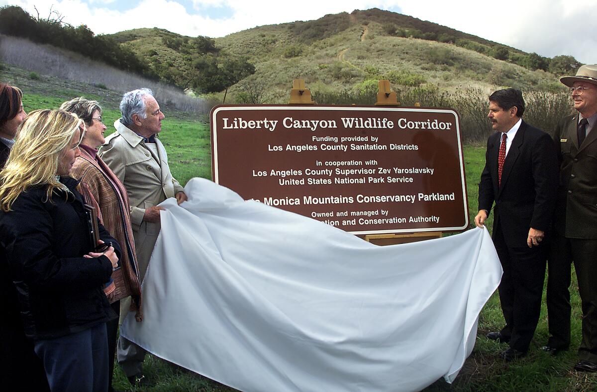 sign for Liberty Canyon Wildlife Corridor is unveiled by a group of people