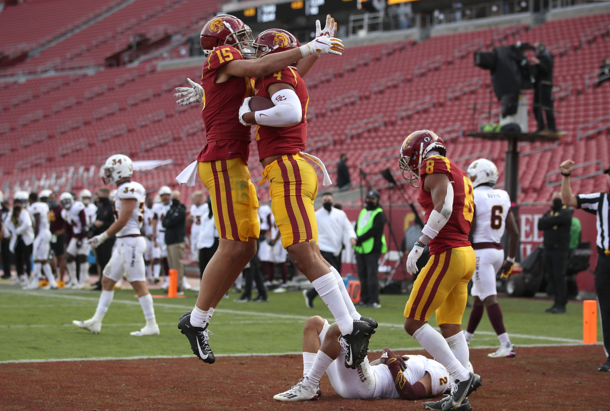 Drake London congratulates Bru McCoy of the USC Trojans after his touchdown catch.