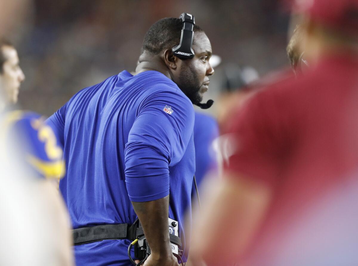 Rams defensive line coach Eric Henderson stands on the sideline during a game.