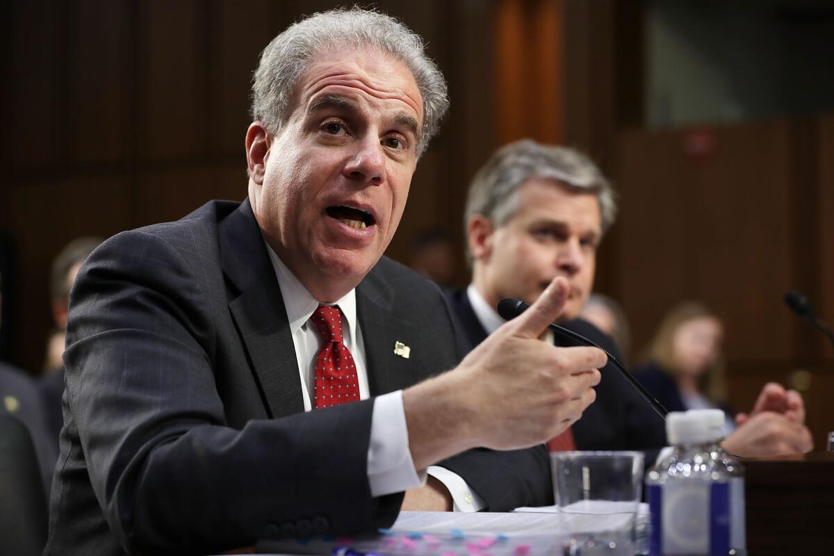 Justice Department Inspector General Michael Horowitz, foreground, and FBI Director Christopher A. Wray testify before the Senate Judiciary Committee in June 2018. 