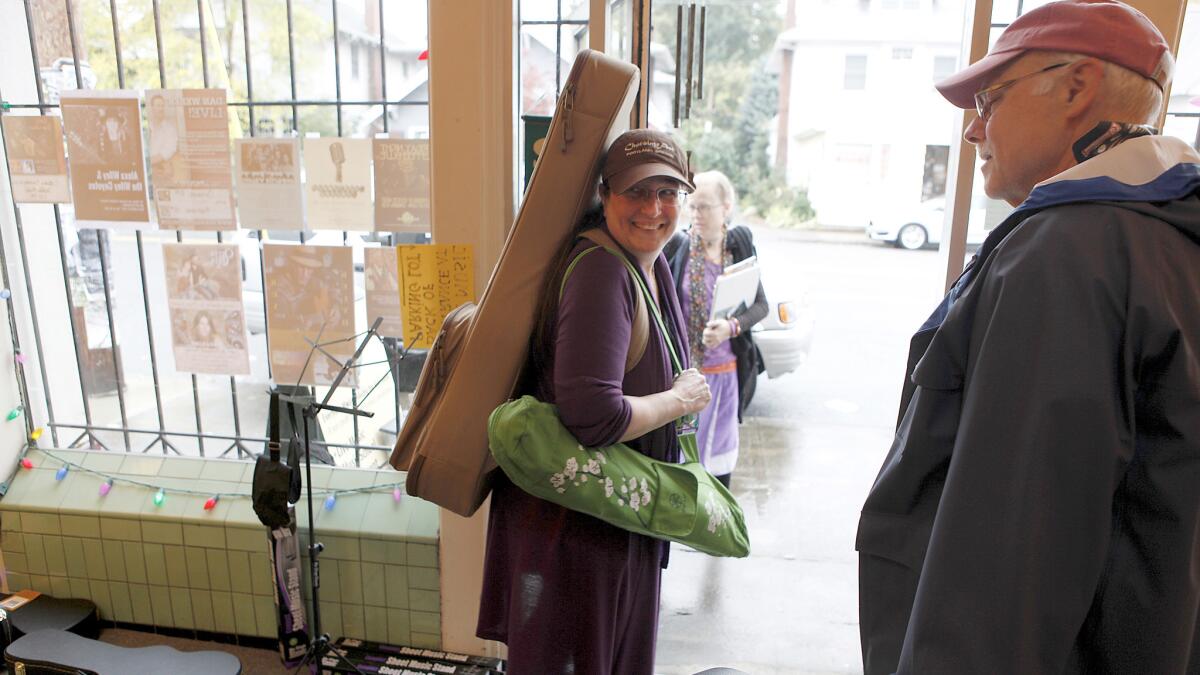 Trish Woodbury, 62, a veteran of both the Army and National Guard, leaves a gathering of Soldier Songs and Voices at Artichoke Music in Portland.