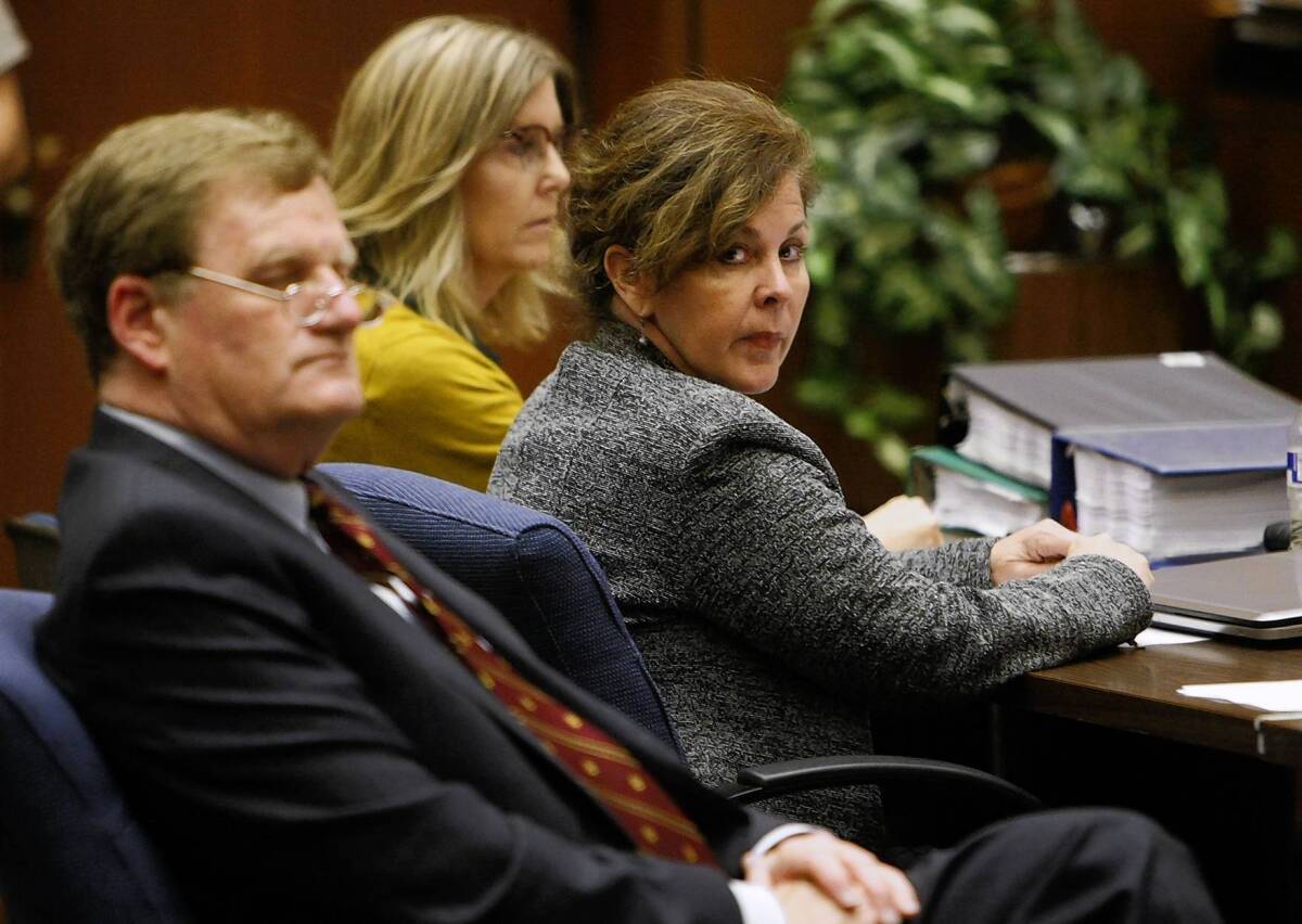 FORMER BELL Assistant City Manager Angela Spaccia, center, who is charged with misappropriation of public funds and other criminal counts, listens to opening statements in Los Angeles County Superior Court at her trial. At left is her attorney Harland Braun; behind her is investigator Leslie Robertson.