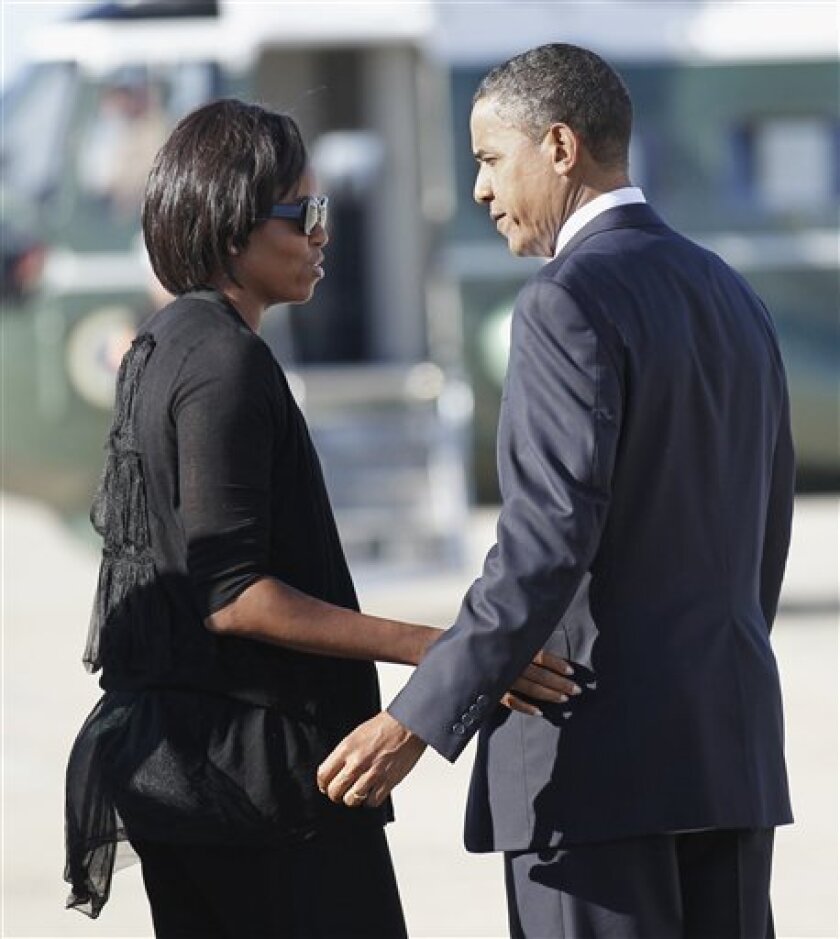 President Barack Obama and first lady Michelle Obama, left, meet on the tarmac as they both return to Andrews Air Force Base, Md., Wednesday, Sept., 8, 2010. Obama was returning from an event in Cleveland area, and the first lady was returning from New Orleans. (AP Photo/Pablo Martinez Monsivais)