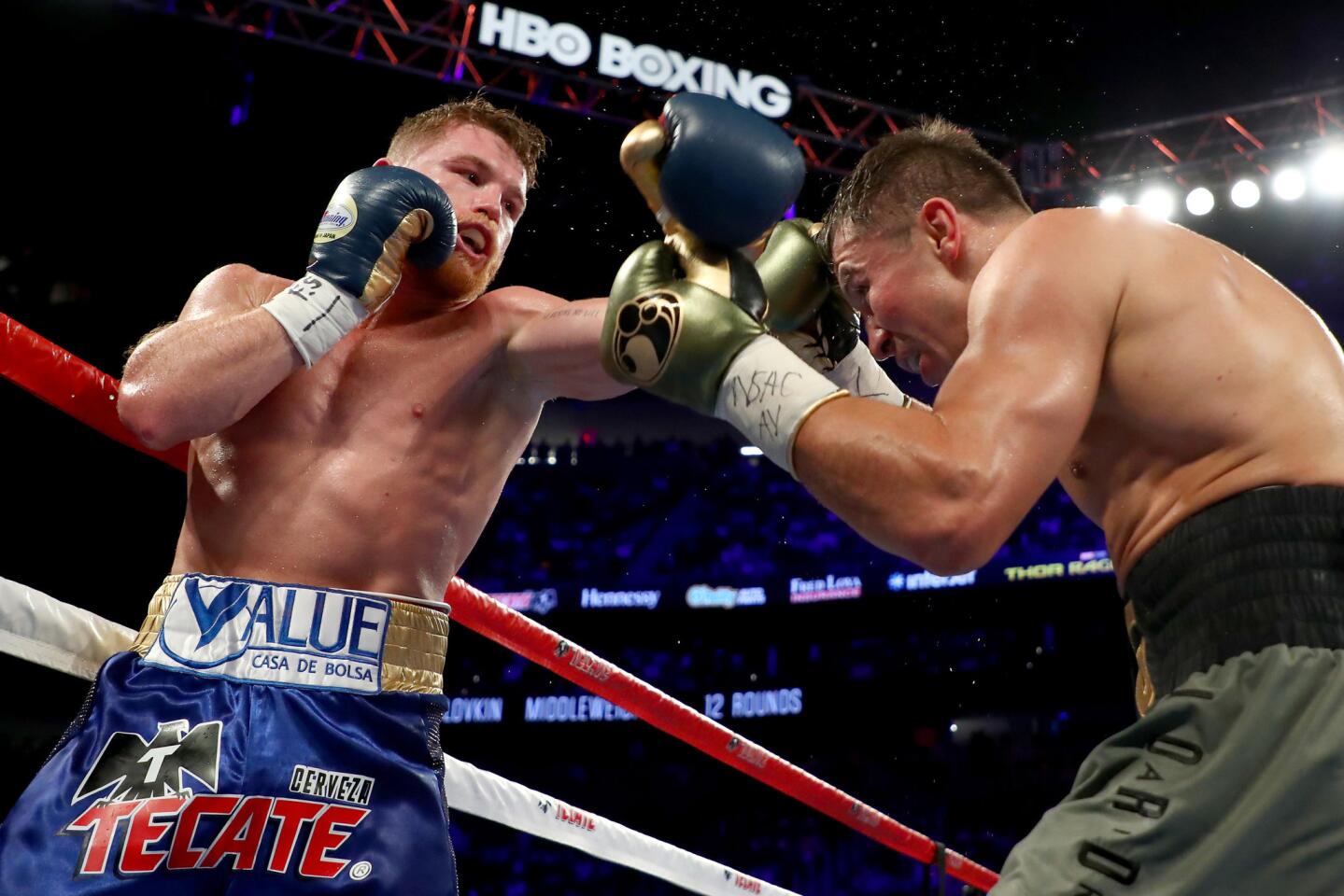 Gennady Golovkin, right, tries to evade a punch by Canelo Alvarez during their middleweight championionship bout.