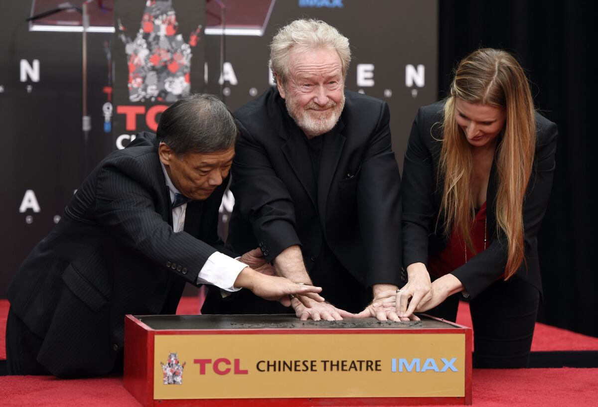 Sir Ridley Scott, director of "Alien: Covenant" presses his handprints into cement during a ceremony for him at the TCL Chinese Theatre on Wednesday, May 17, 2017. (Photo by Chris Pizzello /Invision / AP)