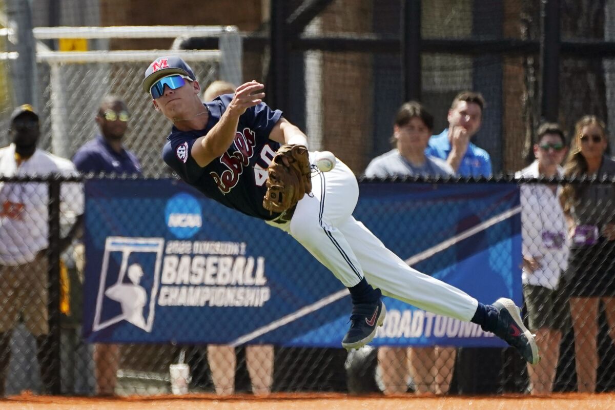 Mississippi infielder Garrett Wood (40) fires an off-balance throw to first during an NCAA college baseball super regional game against Southern Mississippi, Sunday, June 12, 2022, in Hattiesburg, Miss. (AP Photo/Rogelio V. Solis)