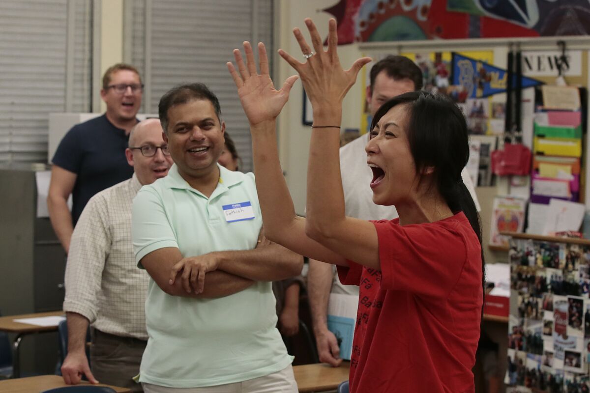 High School social institutions teacher Grace Kim-Oh tries to energize parents as she explains a classroom exercise their children participate in at Cleveland Humanities Magnet School.