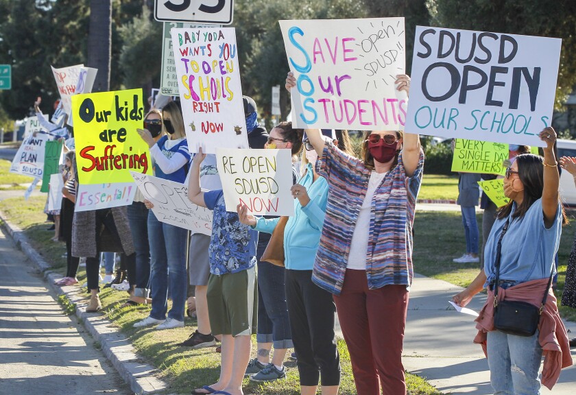Parents and students rally to reopen schools outside the San Diego Unified Headquarters on Feb. 23.