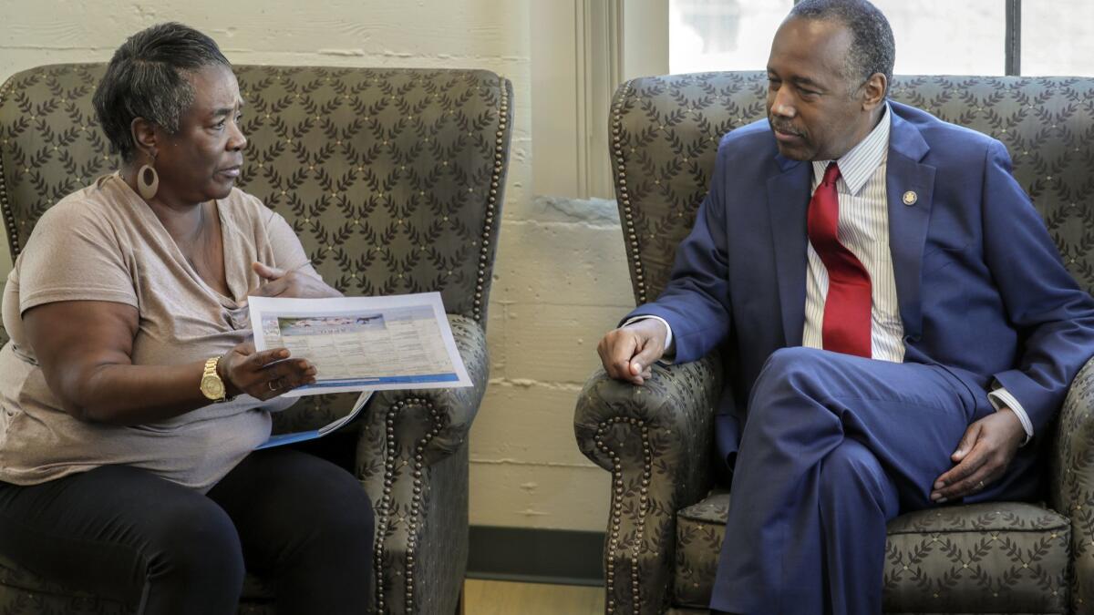 Housing and Urban Development Secretary Ben Carson meets volunteer aide and participant Denise Smith while visiting the Downtown Women's Center in Los Angeles on Tuesday.