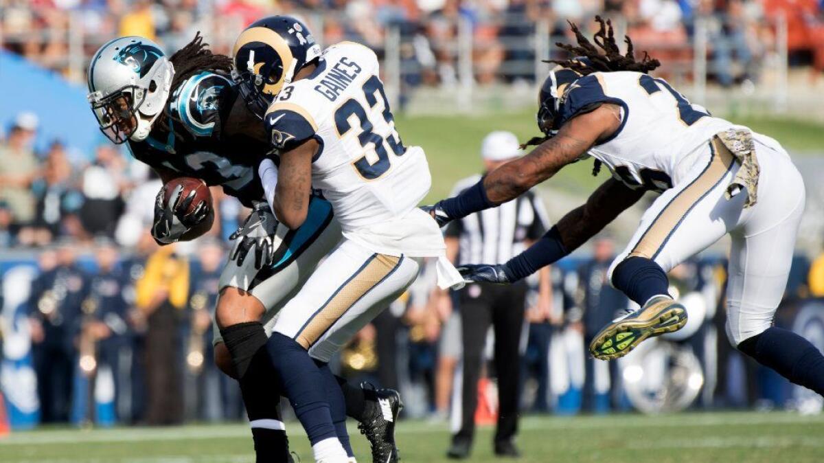 Rams cornerback E.J. Gaines and linebacker Mark Barron try to bring down Panthers receiver Kelvin Benjamin during the second quarter of a game last weekend.