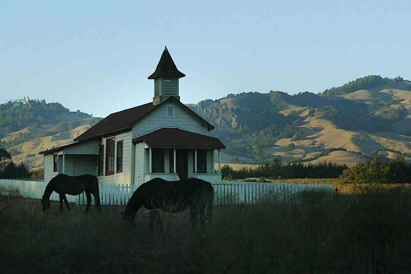 Spencer Weiner 805–653–7527 –– – An old schoolhouse in historic old San Simeon Village frames some of the 83,000–acre Hearst Ranch, the vast property that has been in the Hearst family since the 1860s. The Hearst Ranch has entered a tentative conservation deal with the state to sell some land West of Highway One and restrict development through a conservation easement on the much of the rest of it.