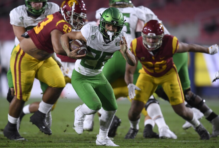 Oregon running back Travis Dye carries the ball against USC in the Pac-12 championship game on Dec. 18 at the Coliseum.
