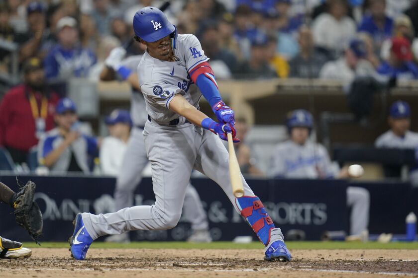 Los Angeles Dodgers' Miguel Vargas hits a two-run single during the sixth inning of the team's baseball game against the San Diego Padres, Thursday, Sept. 29, 2022, in San Diego. (AP Photo/Gregory Bull)