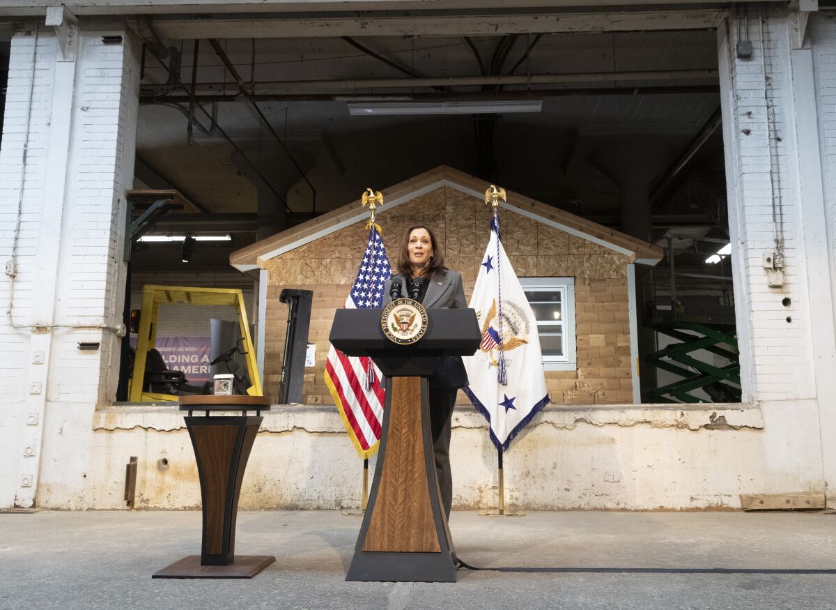 Vice President Kamala Harris speaks outside at a lectern.