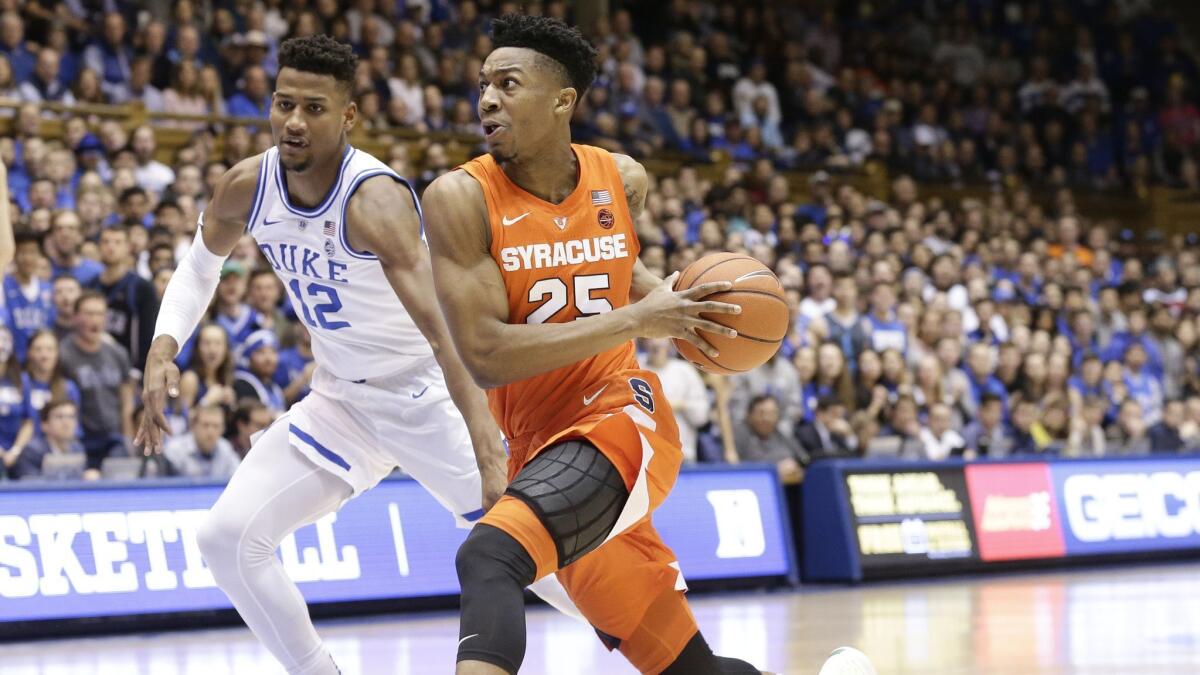 Duke's Javin DeLaurier (12) guards Syracuse's Tyus Battle (25) during the first half.