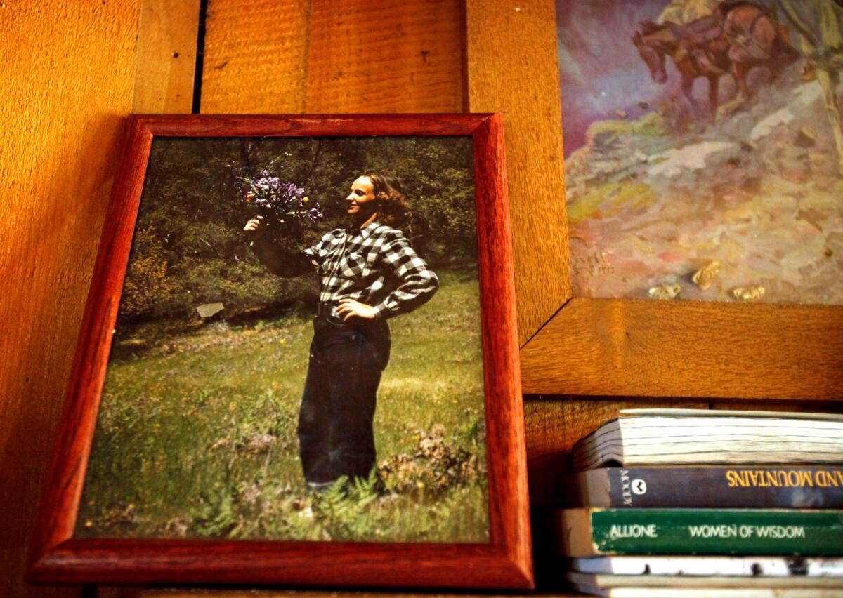 An 8x10 photograph of Mary English sits on the left side of the mantel above the fireplace. The picture, which was taken by Jack in the 1950s, shows young Mary holding up an impromptu bouquet of wild iris, harebells and shooting stars. (Barbara Davidson / Los Angeles Times)