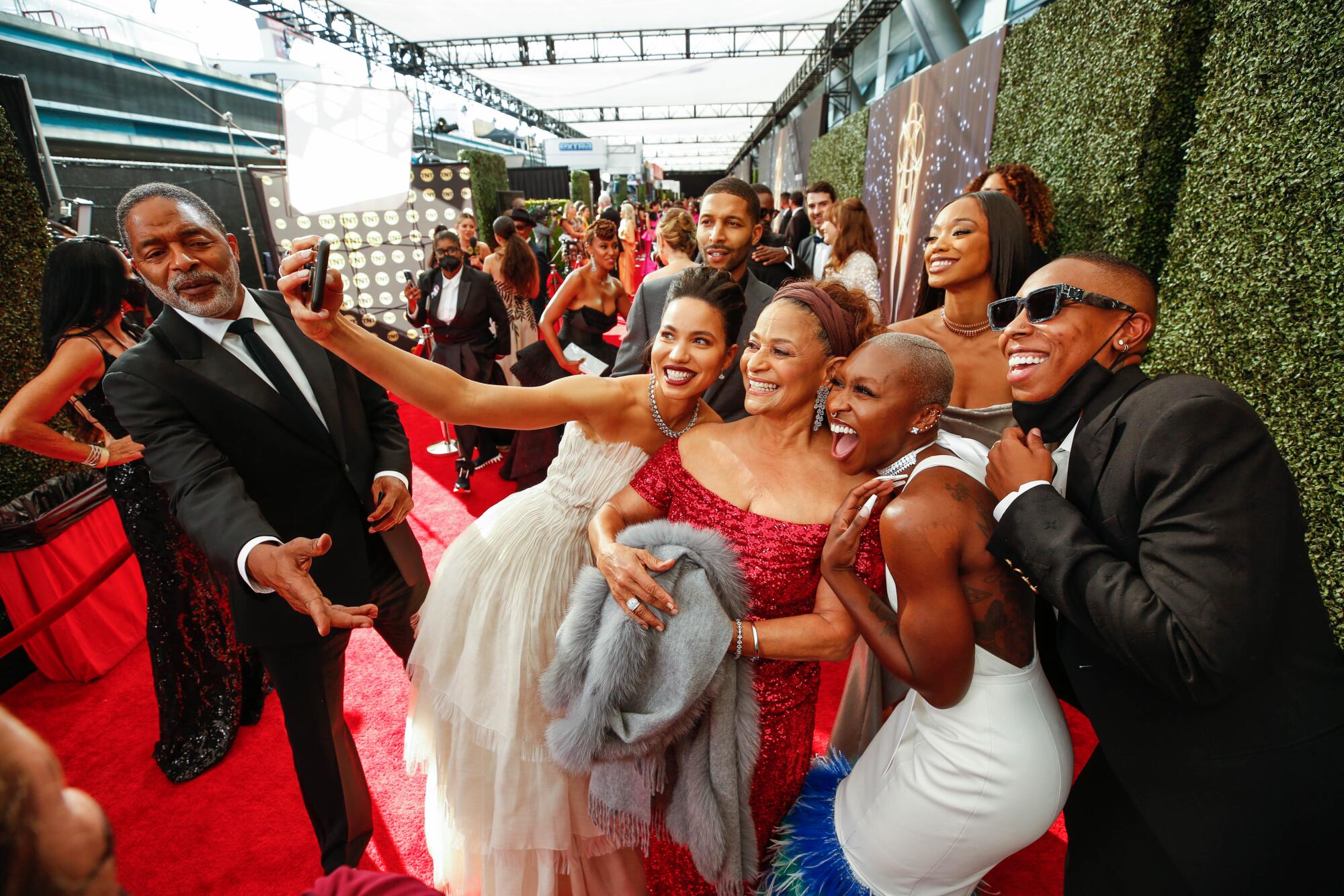 People gather for a selfie with Debbie Allen on the red carpet.