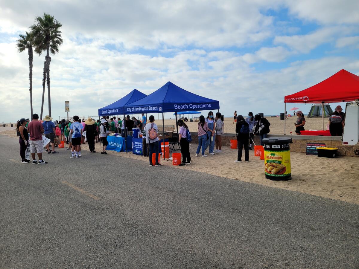 Volunteers gather for a cleanup event at Huntington Beach.