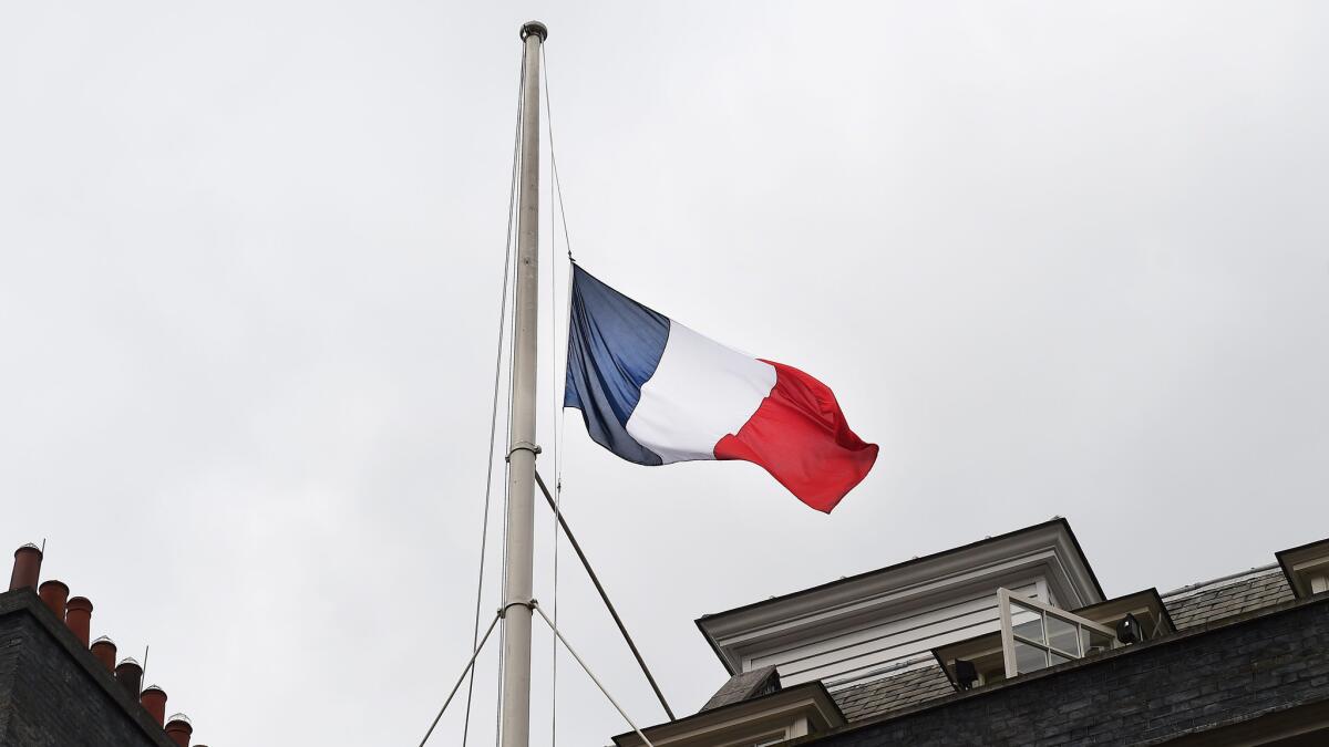 The French tricolor flag flies at half-staff over 10 Downing Street in London on July 15.