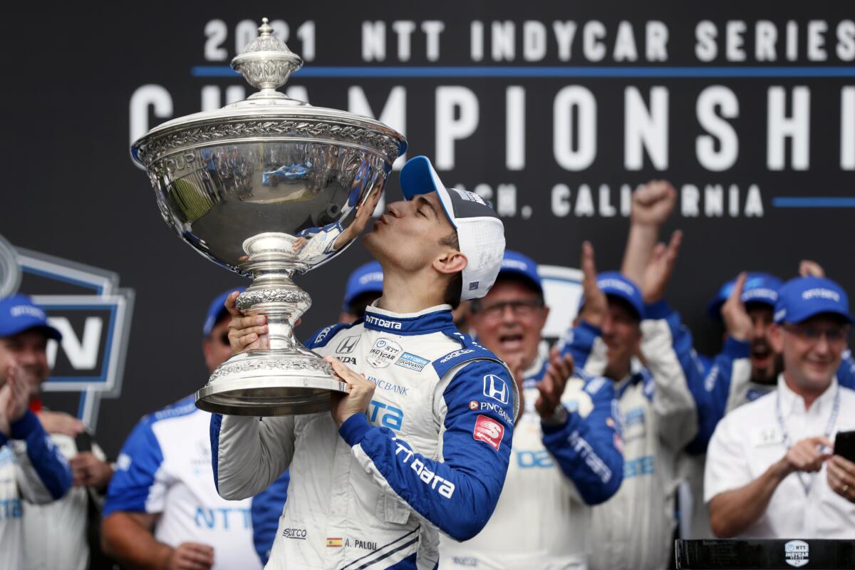 NTT IndyCar Series winner Alex Palou, center, celebrates with the tro 