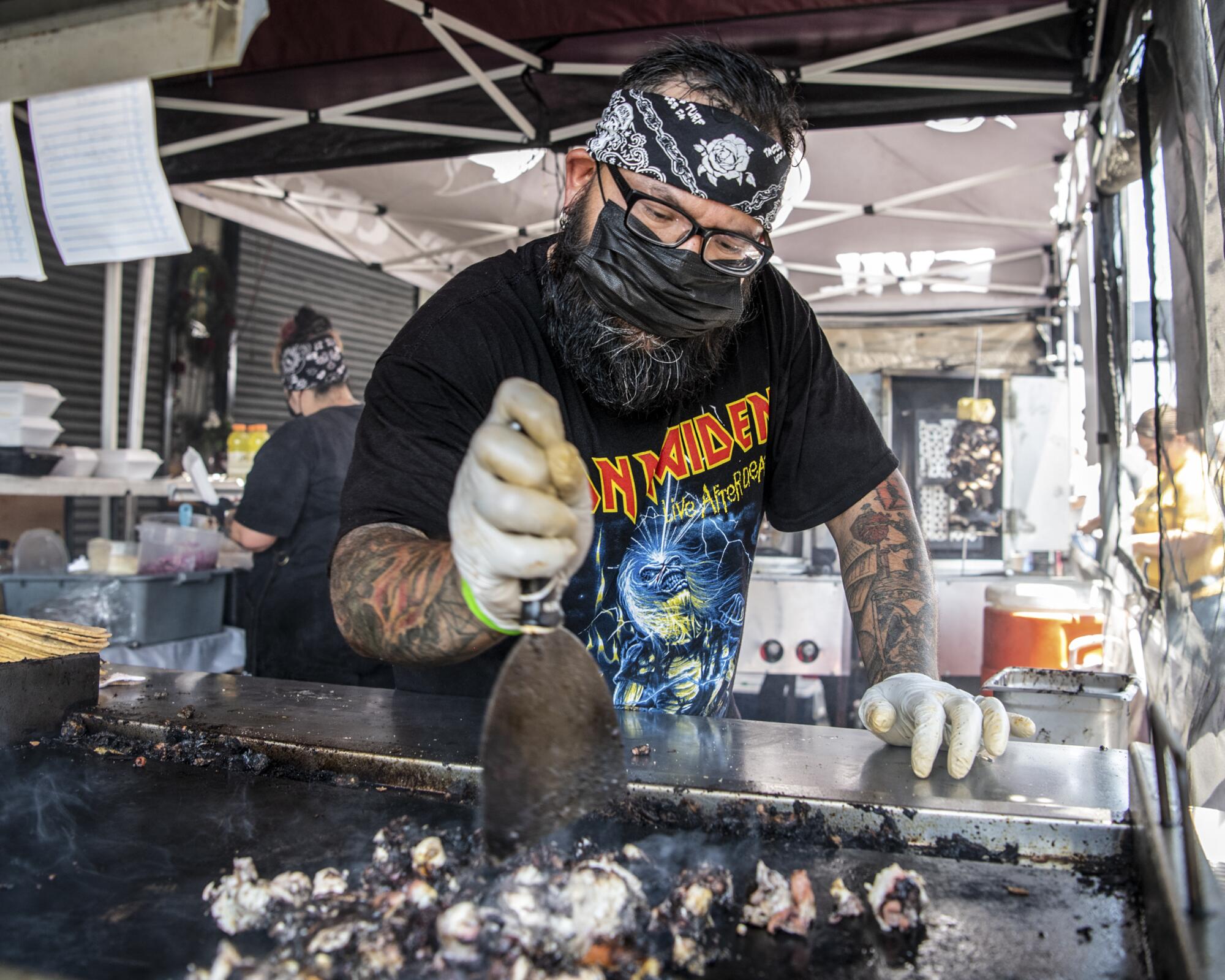 Alex Garcia prepares octopus at Evil Cooks