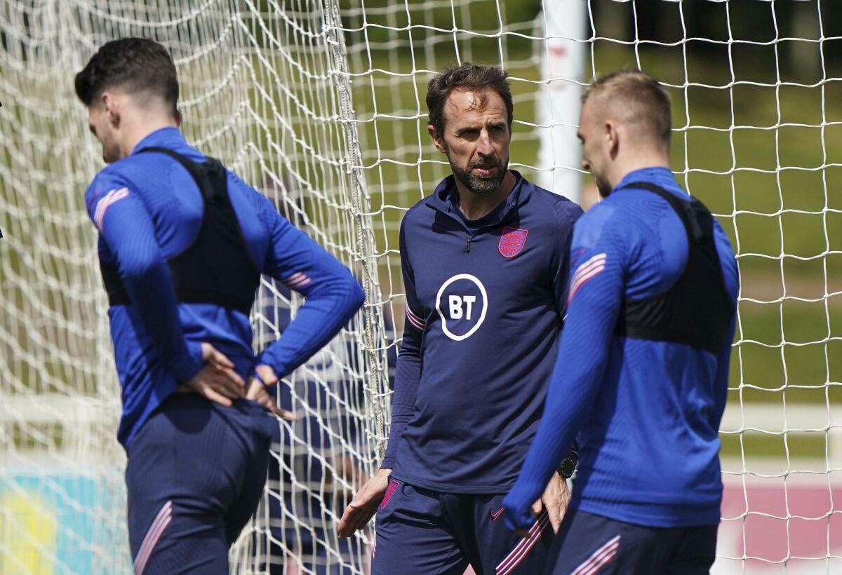 England's manager Gareth Southgate, center, talks to his players during a training session at St George's Park, Burton-upon-Trent, England, Friday June 10, 2022. (Joe Giddens/PA via AP)