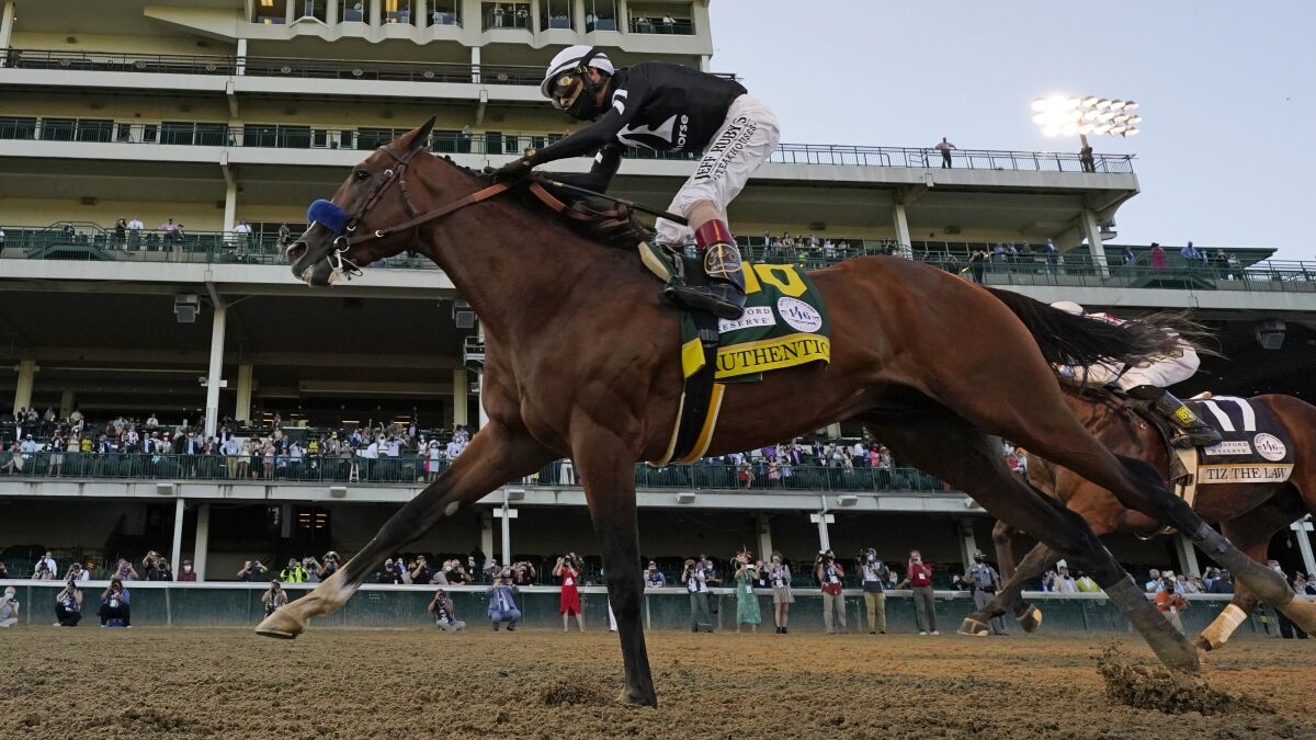 Jockey John Velazquez riding Authentic crosses the finish line to win the 146th running of the Kentucky Derby on Sept. 5.
