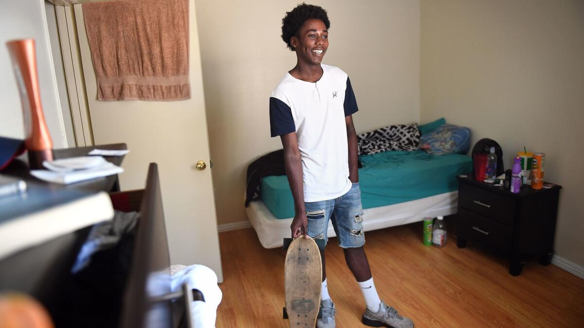 Eric Usher, seen in his L.A. apartment, is in "extended foster care," which lets 18- to 21-year-olds continue receiving housing, funding and support services.