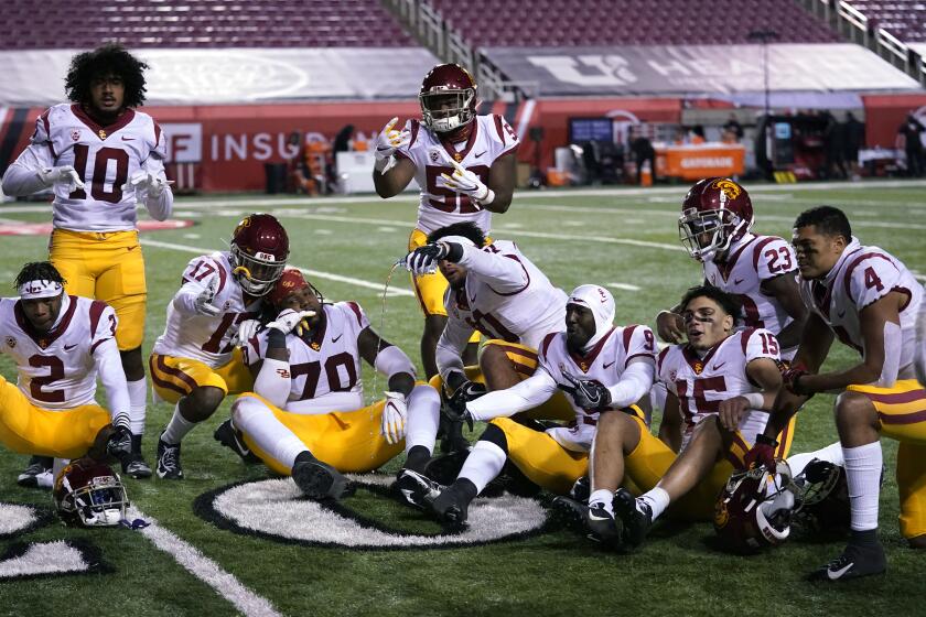 Southern California players pose for a photograph after their NCAA college football game against Utah