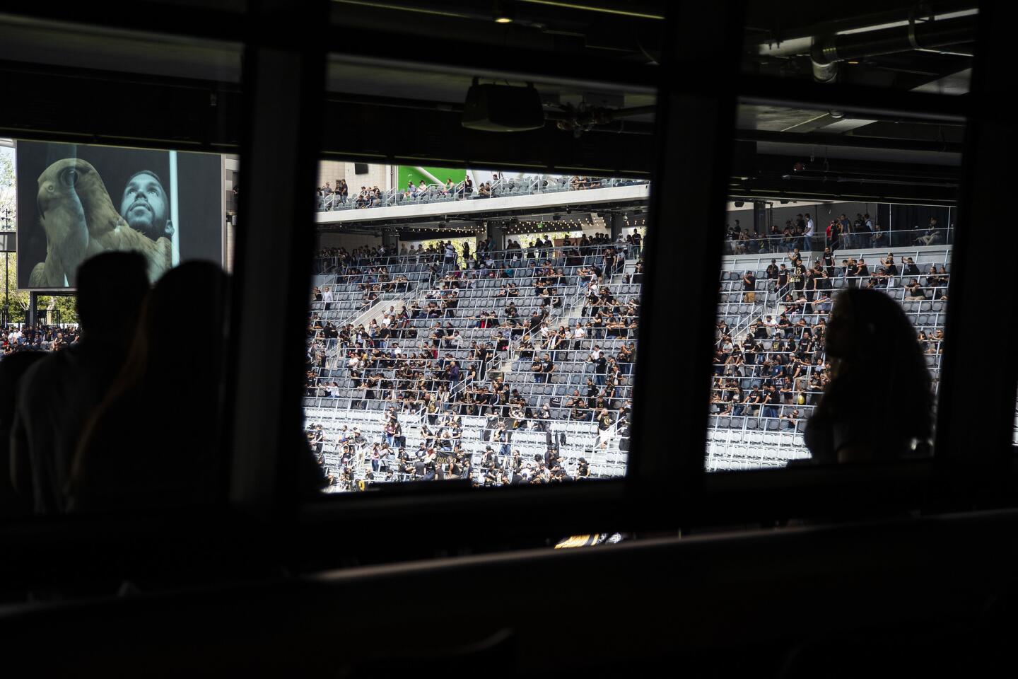 Fans watch a halftime show from the deck outside the Figueroa Club inside the new Banc of California Stadium on April 21.