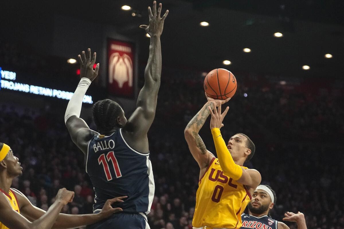 USC's Kobe Johnson looks to shoot over Arizona's Oumar Ballo during the first half.