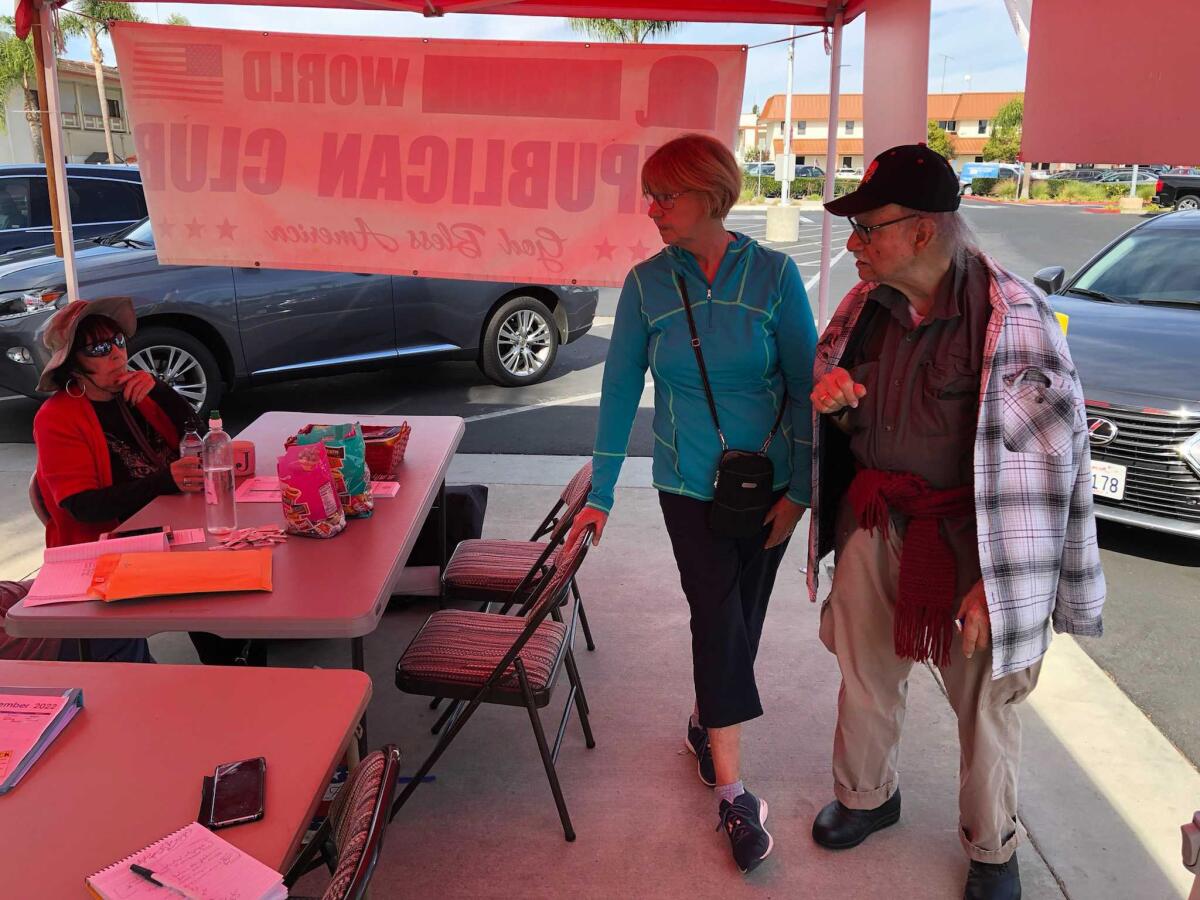 Anne and Jose Calvo stop at a table set up by the Republican Club at Leisure World in Seal Beach.