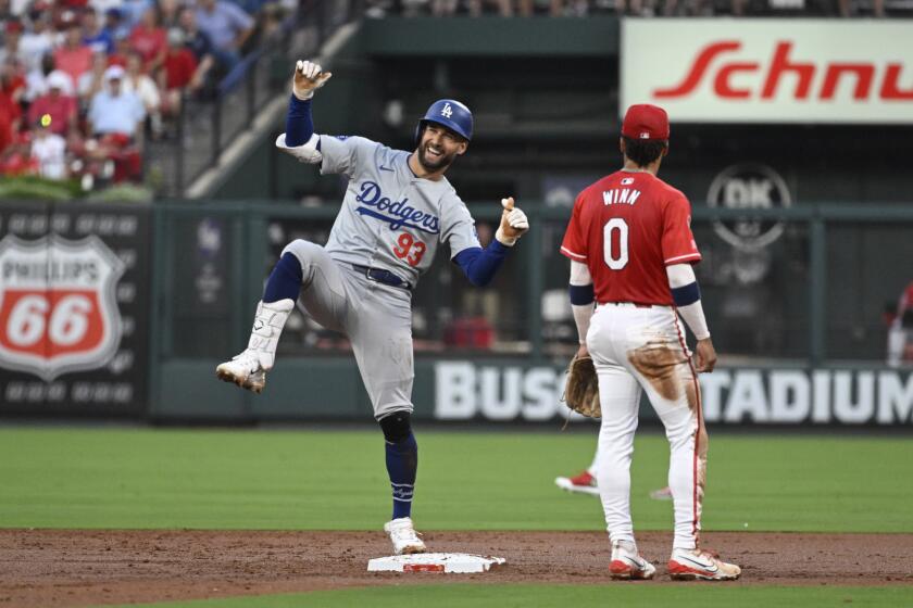 Los Angeles Dodgers' Kevin Kiermaier (93) reacts after advancing to second on a throwing error form St. Louis Cardinals right fielder Jordan Walker (not shown) during the first inning of a baseball game Friday, Aug. 16, 2024, in St. Louis. (AP Photo/Jeff Le)