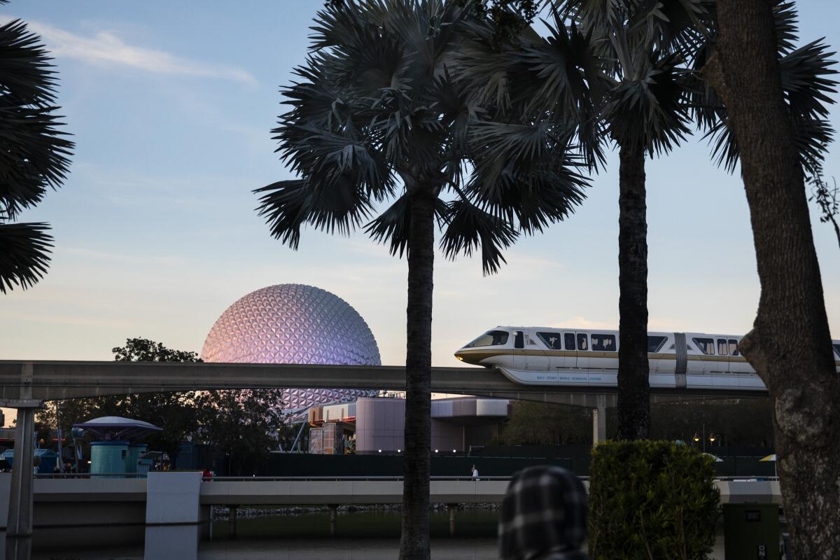 The Walt Disney World monorail glides past Epcot's Spaceship Earth.