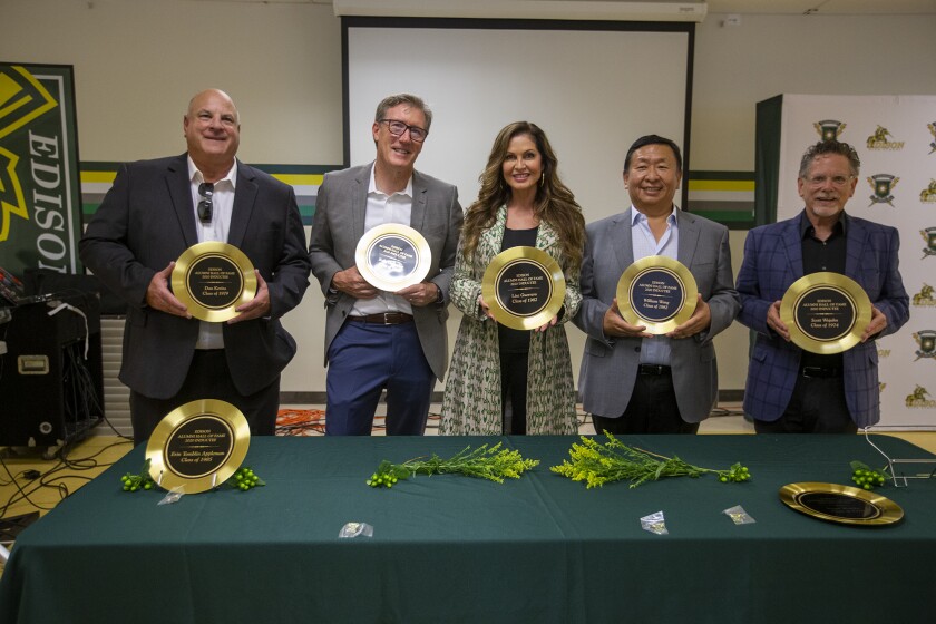 Dan Kerins, left, Kelly Gallagher, Lisa Guerrero, William Wang and Scott Wojahn hold their Hall of Fame awards.