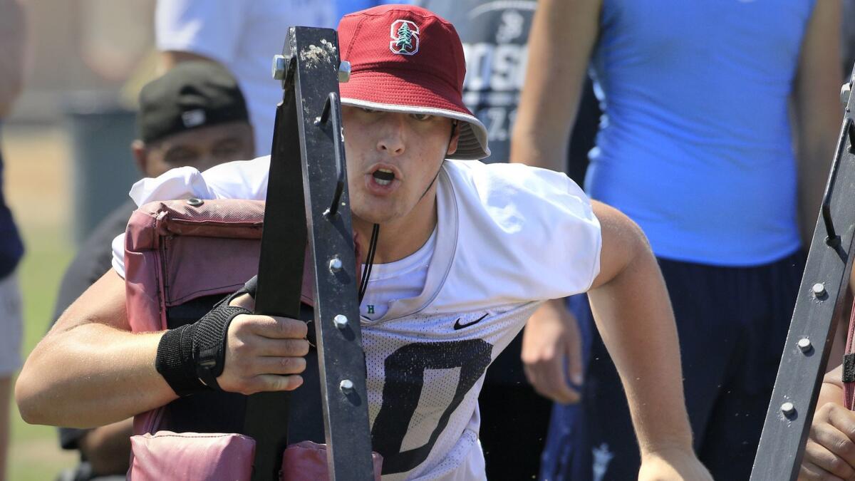 St. John Bosco guard Drake Metcalf drives his portion of the two-man sled during lineman competition at the Mission Viejo.