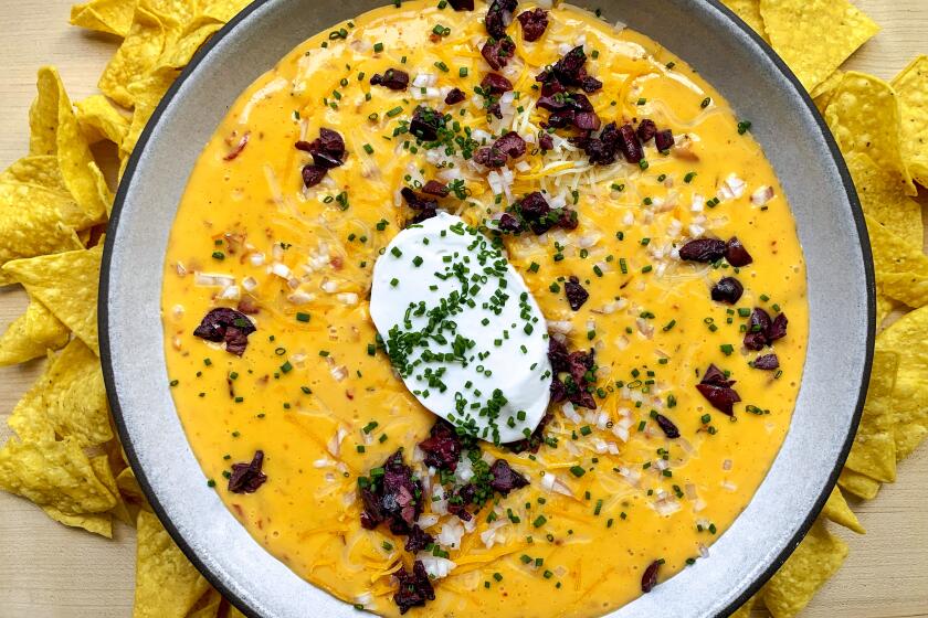 Pimiento Queso: Orange dip with tortilla chips.