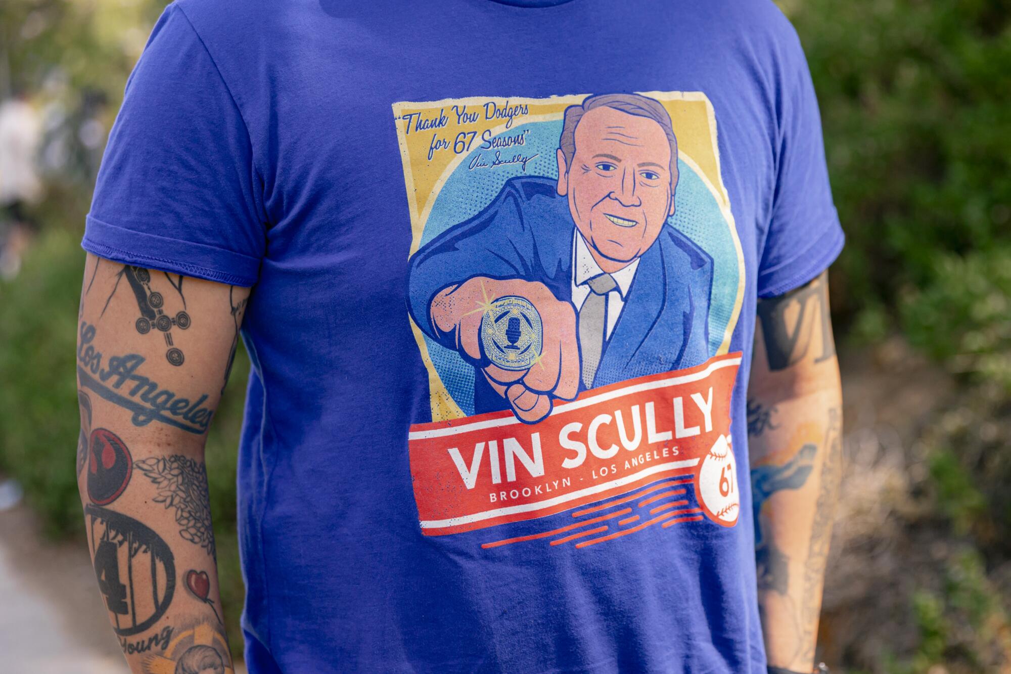 Alain Gomez stands for a portrait in his Vin Scully shirt.