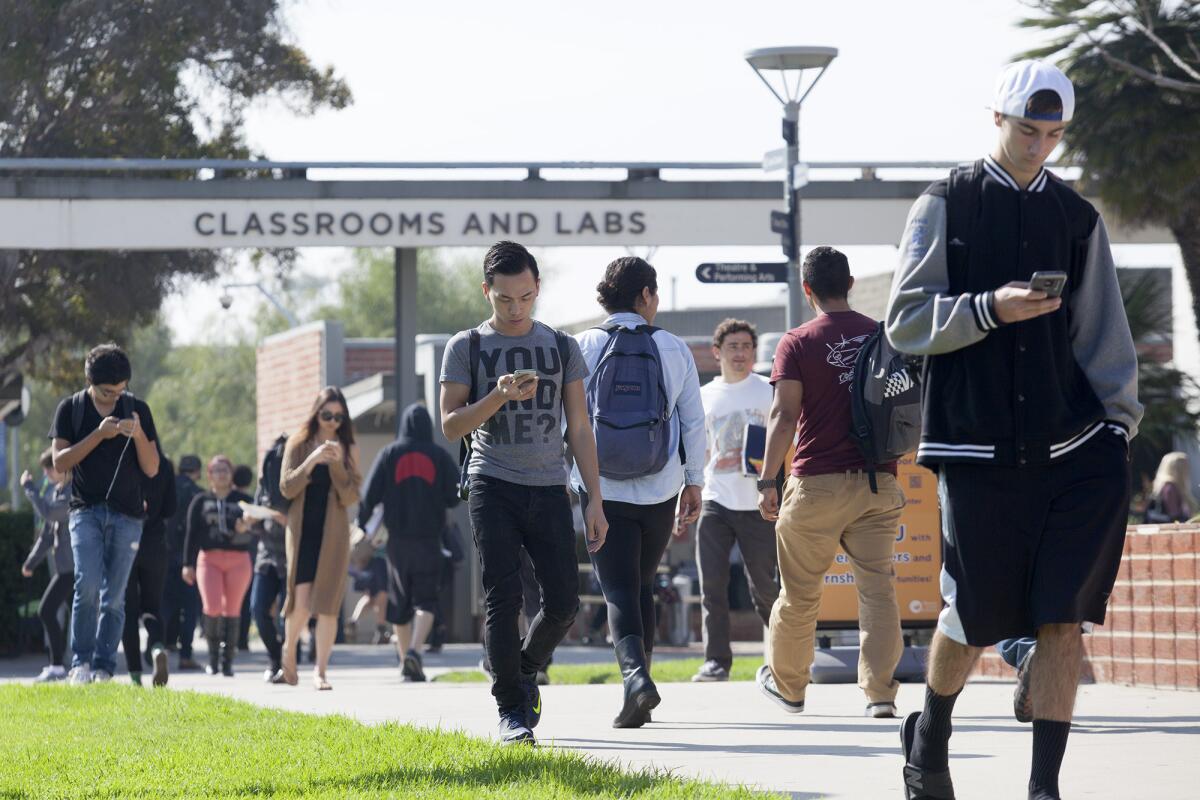 Students make their way to and from classes during their first week of the spring semester at Orange Coast College on Tuesday.