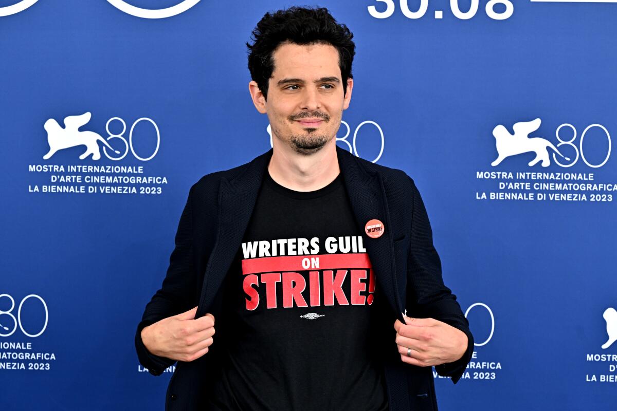 A man in a Writers Guild on Strike T-shirt and black blazer.