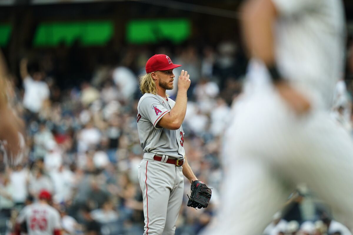 Angels pitcher Noah Syndergaard reacts as New York Yankees' Matt Carpenter runs the bases after hitting a two-run home run.