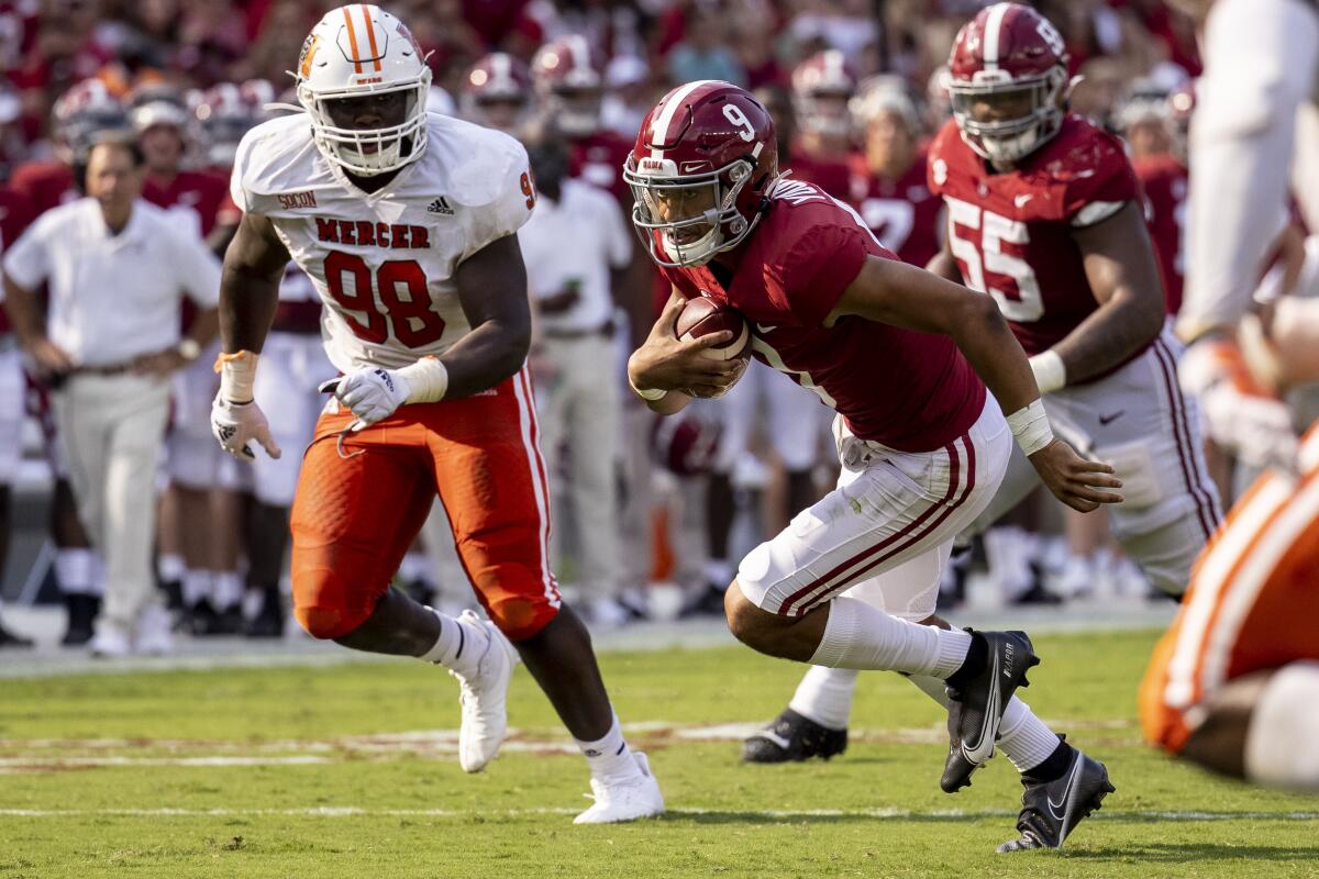 Alabama quarterback Bryce Young runs against Mercer during the first half Sept. 11, 2021.