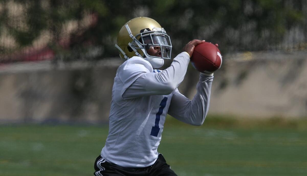 UCLA receiver Ishmael Adams catches a pass during a training camp practice Aug. 8.